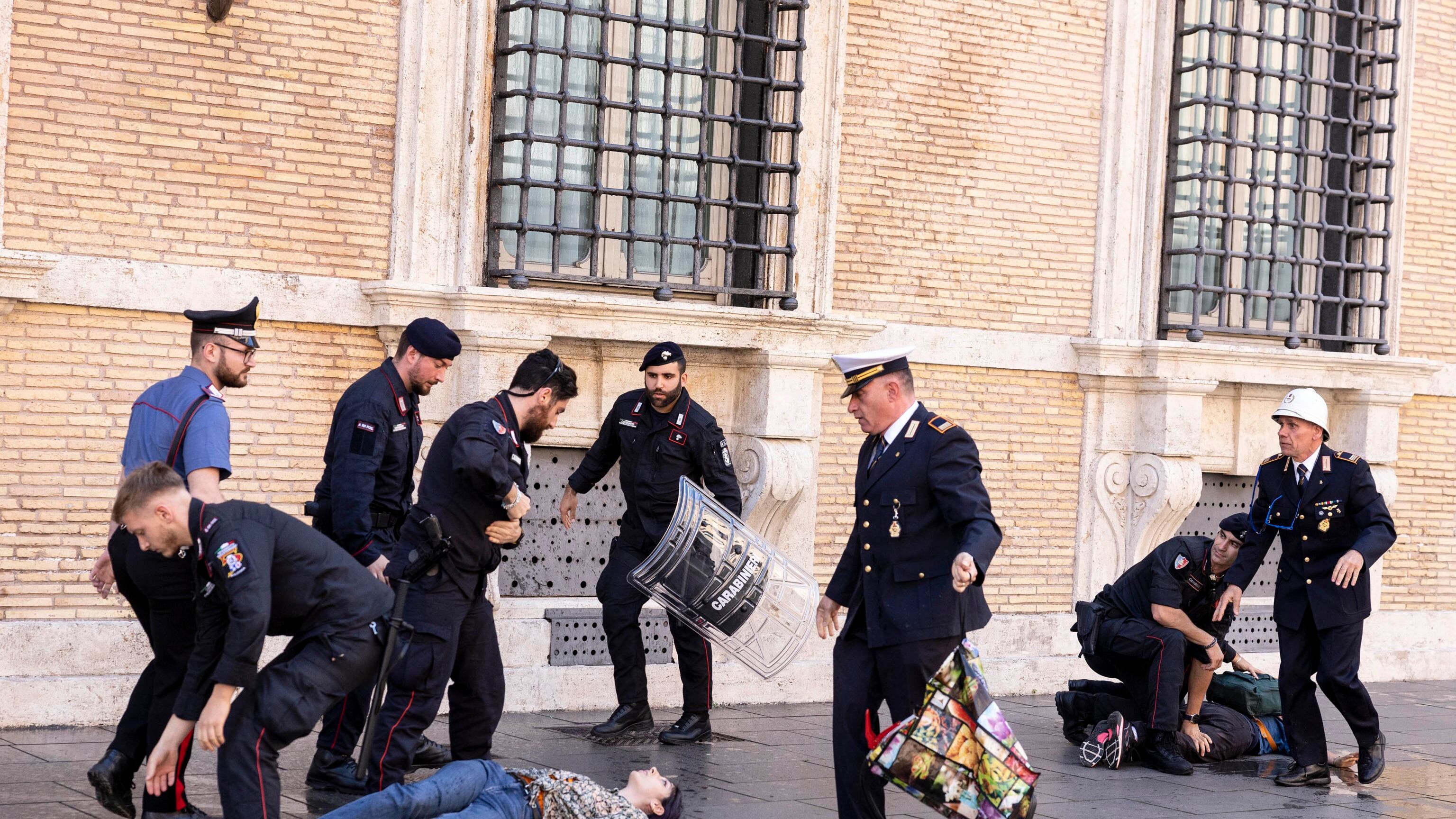 Gli ecovandali in azione per imbrattare il Senato. Portati via dagli agenti