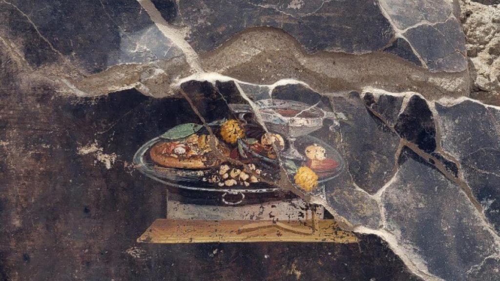 La "pizza" nell'affresco di Pompei: ecco la storia del cibo italiano per eccellenza