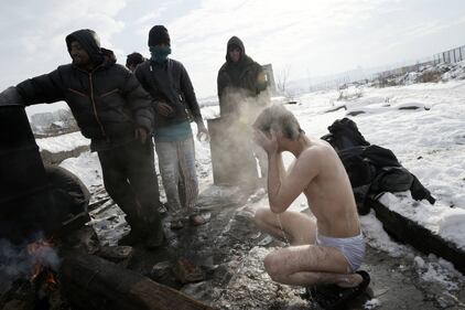 Immigrati bloccati a Belgrado costretti a lavarsi tra la neve 1