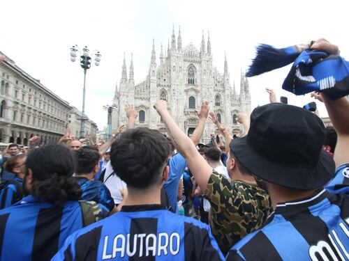 Davanti al Duomo di Milano tra cori, bandiere e sfottò